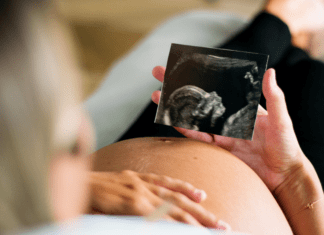 A pregnant woman looking at her sonogram.