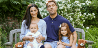 A family sitting on a bench.