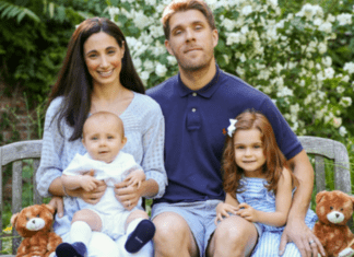 A family sitting on a bench.