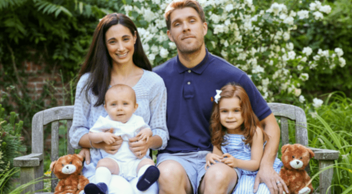 A family sitting on a bench.