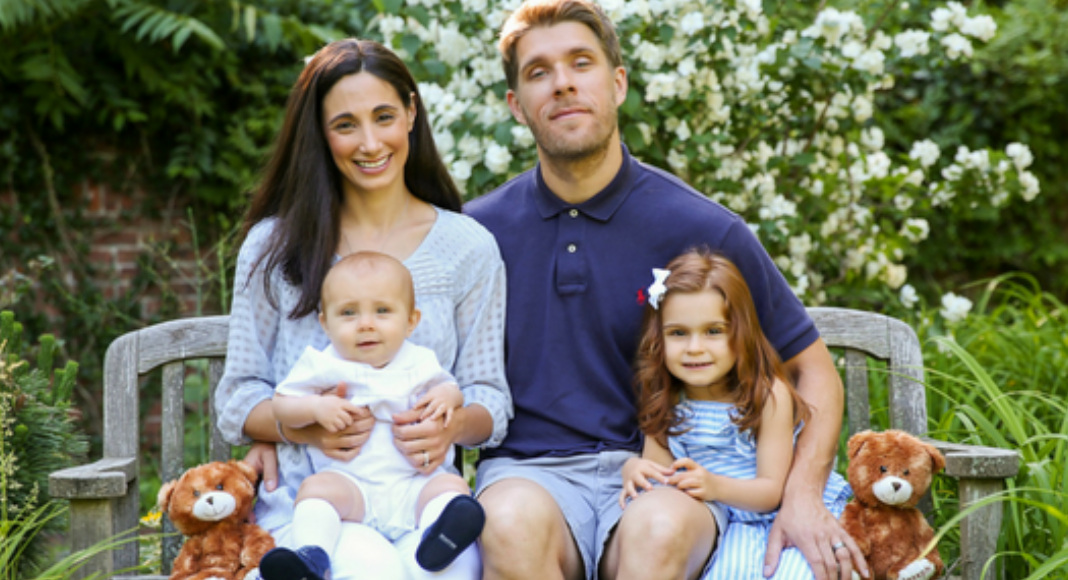 A family sitting on a bench.