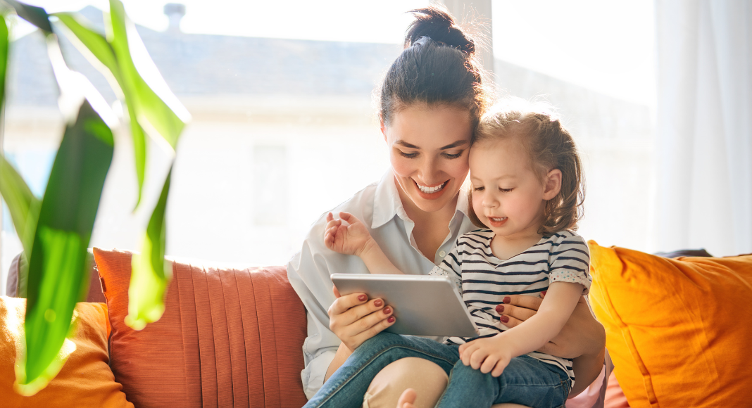 A mother reading to her daughter. 