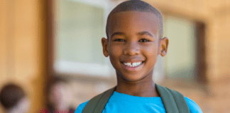 White Mom, Black Son, Gray World: Guns A black boy wearing a backpack.