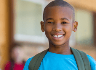 White Mom, Black Son, Gray World: Guns A black boy wearing a backpack.