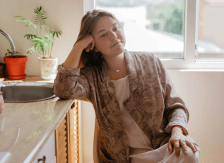 A woman sitting in her kitchen.