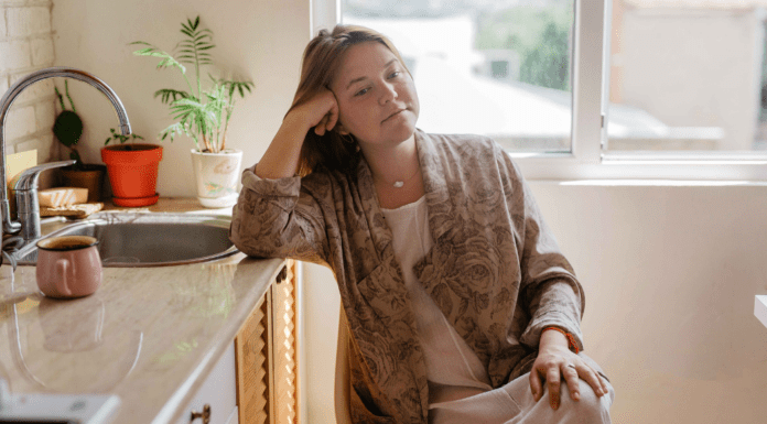 A woman sitting in her kitchen.