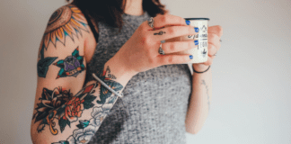 Tattoo – Why I Decided to Get One After 40 A woman with tattoos holding a coffee cup.