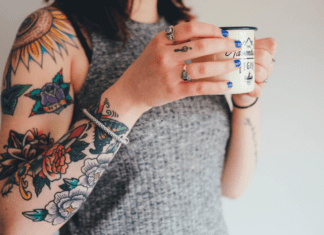 Tattoo – Why I Decided to Get One After 40 A woman with tattoos holding a coffee cup.