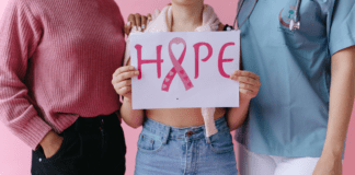 October is Breast Cancer Awareness Month Holding a sign of hope for breast cancer awareness.