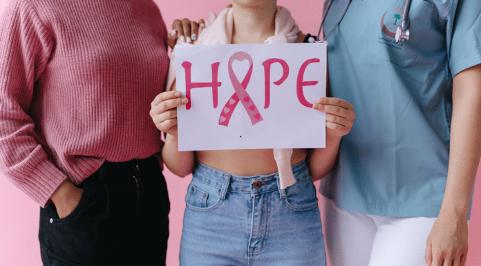October is Breast Cancer Awareness Month Holding a sign of hope for breast cancer awareness.
