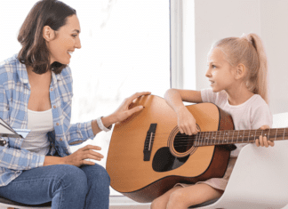 Music Lessons For My Little Rock Star A girl taking a guitar music lesson.