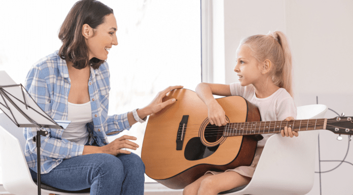 Music Lessons For My Little Rock Star A girl taking a guitar music lesson.