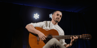 A man playing a guitar.