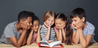 Diverse children reading a book together.