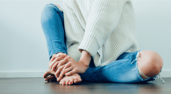 A woman sitting on the floor.