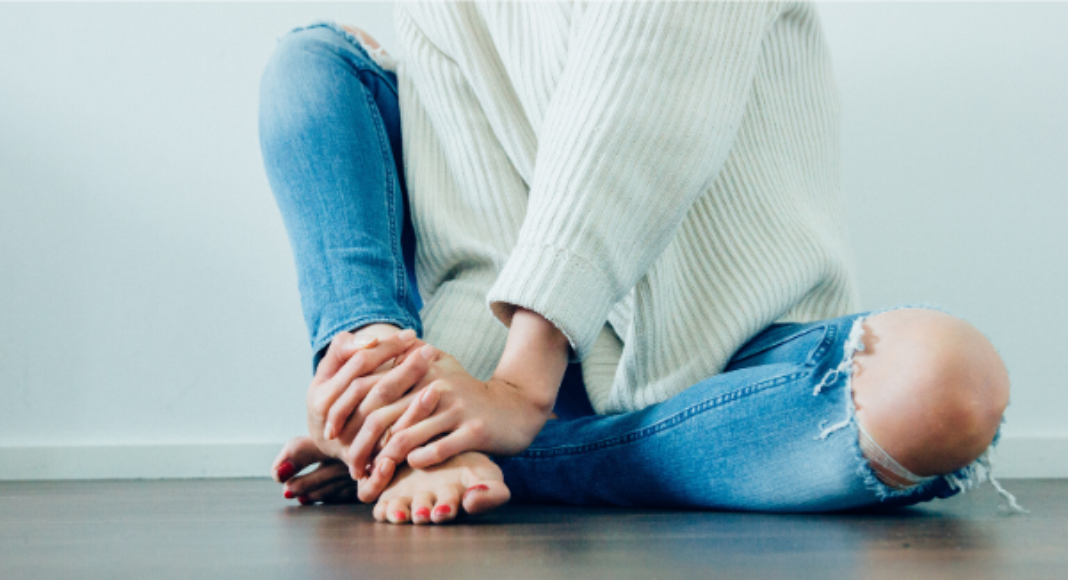 A woman sitting on the floor.