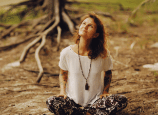A woman sitting next to roots.