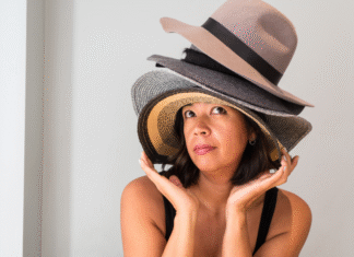 A woman wearing a lot of hats.