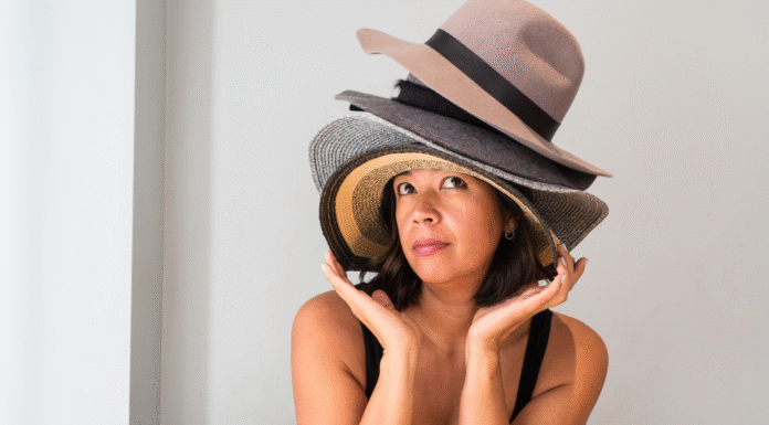 A woman wearing a lot of hats.