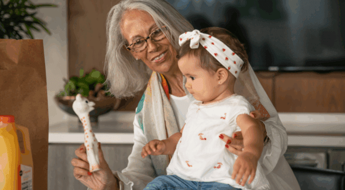 A grandmother holding her toddler granddaughter.
