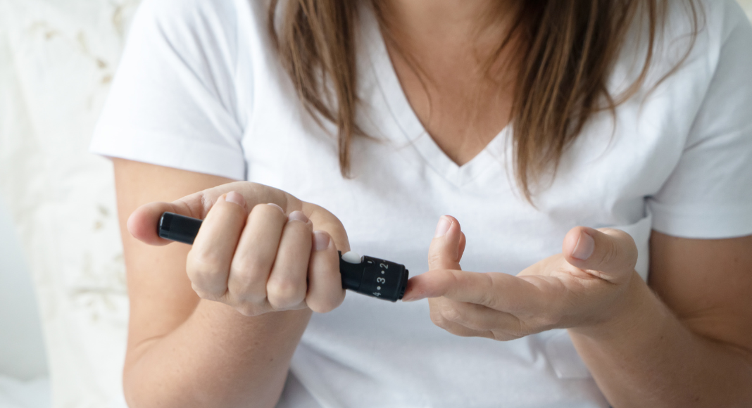 A woman checking her blood sugar.