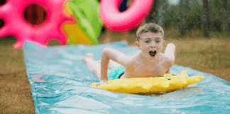 Avoiding the Summer Slide A boy on a slip and slide.