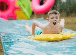 Avoiding the Summer Slide A boy on a slip and slide.