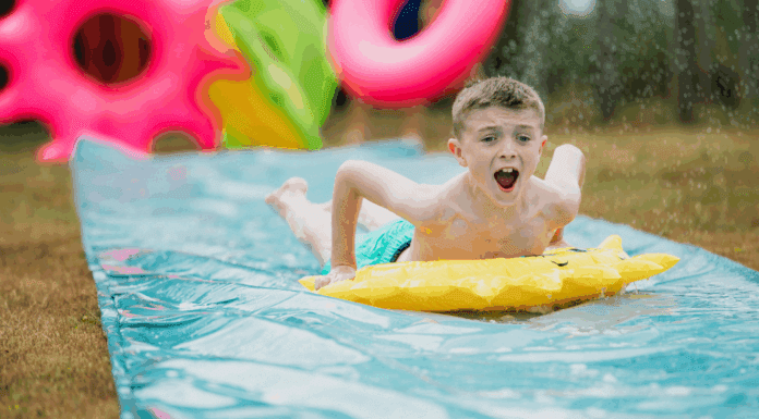 A boy on a slip and slide.