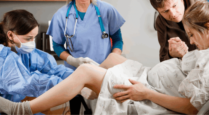 A woman giving birth.