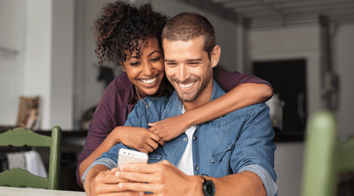 Sex and the Single Mom: The Final Chapter A happy couple looking at a phone.