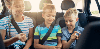 Are We There Yet? How to Survive a Family Car Trip Kids sitting in the back seat of the car on a road trip.