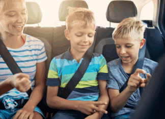 Are We There Yet? How to Survive a Family Car Trip Kids sitting in the back seat of the car on a road trip.