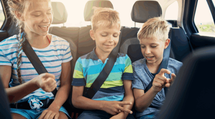 Are We There Yet? How to Survive a Family Car Trip Kids sitting in the back seat of the car on a road trip.