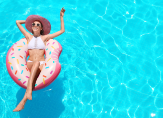 A mom relaxing in a pool on a float.