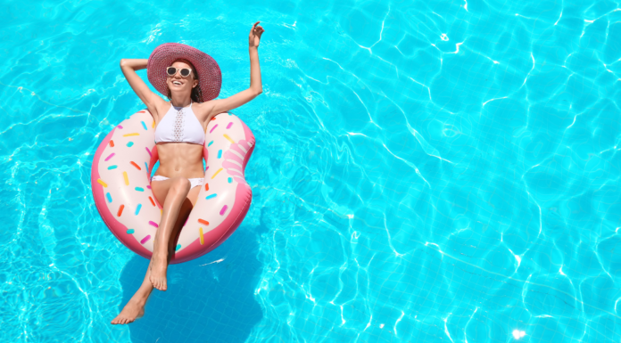 A mom relaxing in a pool on a float.
