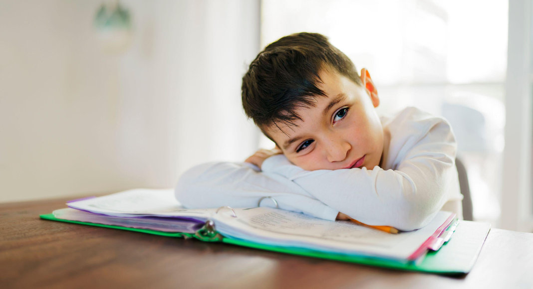 A boy with his head down.