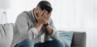 Is Your Husband Depressed? Here are Signs to Look For A man holding his face upset.