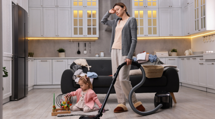 An exhausted mom vacuuming.