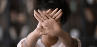5 Things Moms Should Stop Doing Right Now A woman holding up her hands saying stop.