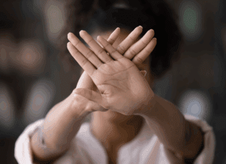 5 Things Moms Should Stop Doing Right Now A woman holding up her hands saying stop.