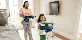 A Mom’s Guide to Tidying Up Before School Starts A mom and daughter putting away folded laundry.