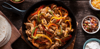 Chicken fajitas in a skillet.