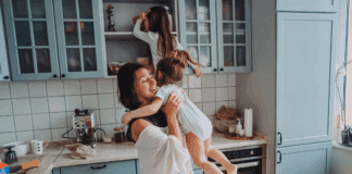 Real Parenting Advice A mom in the kitchen with her daughters climbing on the counters.
