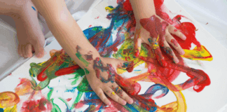 10 Must-Have Art Supplies for Toddlers A child's hands finger painting.