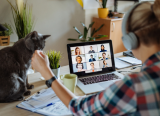 Working From Home When No One Needs You Around Anymore A woman on a Zoom call working from home with her cat.