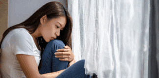 Helping Our Kids to Embrace Disappointment A woman disappointed holding her knees.