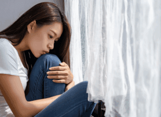 A woman disappointed holding her knees.