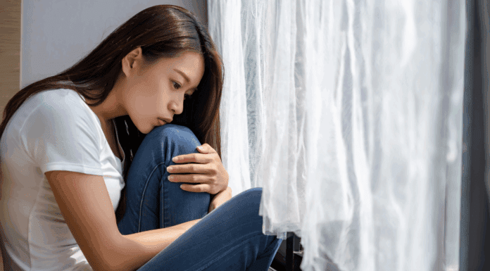A woman disappointed holding her knees.