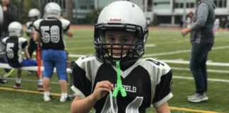 A boy ready to play football.