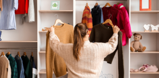 8 Wardrobe Must-Haves from Westchester Mompreneurs A women looking through clothes in her wardrobe.